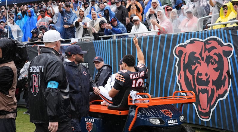 Chicago Bears quarterback Caleb Williams (18) waves as he is carted off the field after an injury during the second half of an NFL football game against the Minnesota Vikings in Chicago, Sunday, Sept. 20, 2026. (AP Photo/Nam Y. Huh)