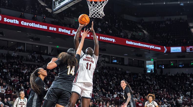South Carolina center Madina Okot (11) shoots the ball over Vanderbilt forward Aiyana Mitchell (14) during the first half of an NCAA college basketball game Sunday, Jan. 25, 2026, in Columbia, S.C. (AP Photo/David Yeazell)