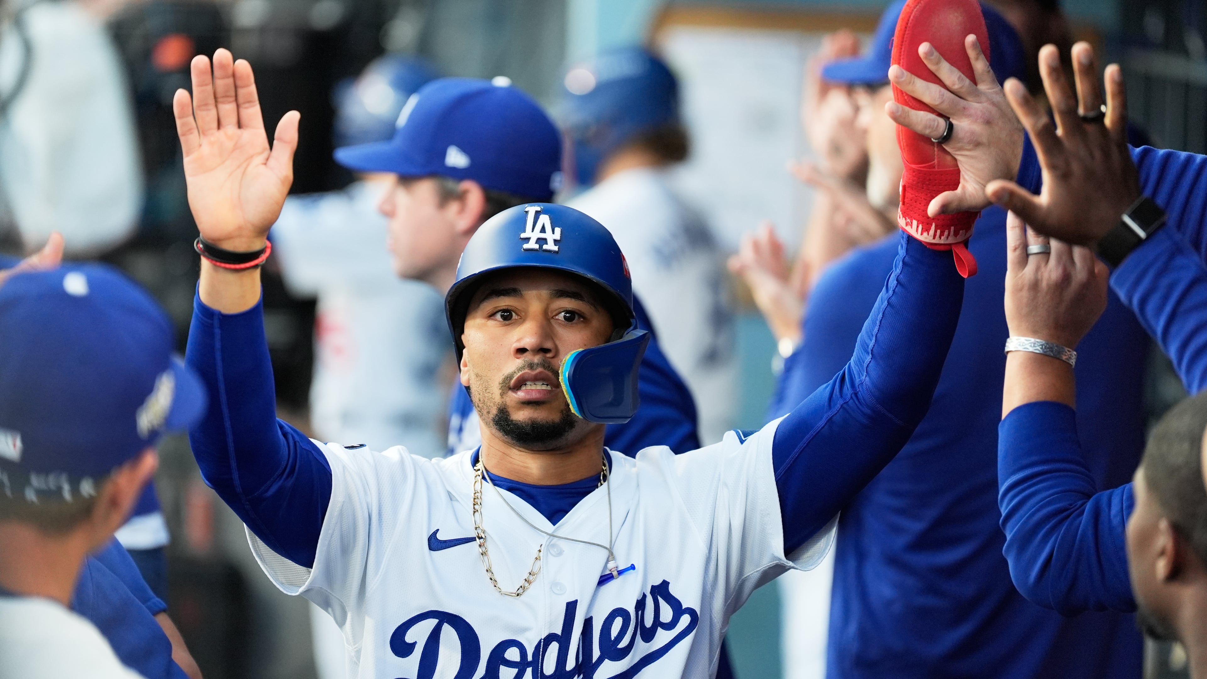 Los Angeles Dodgers' Mookie Betts celebrates in the dugout after scoring against the Milwaukee Brewers during the first inning in Game 4 of baseball's National League Championship Series, Friday, Oct. 17, 2025, in Los Angeles. (AP Photo/Ashley Landis)