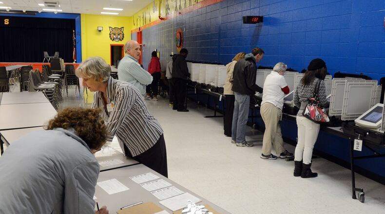 Voters in Jonesboro at the polls during the Nov. 6, 2012 general election. Assistant poll manager Janet Love helps voters as a steady stream of voters came in to the precinct at Suder Elementary school in Jonesboro. KENT D. JOHNSON / AJC