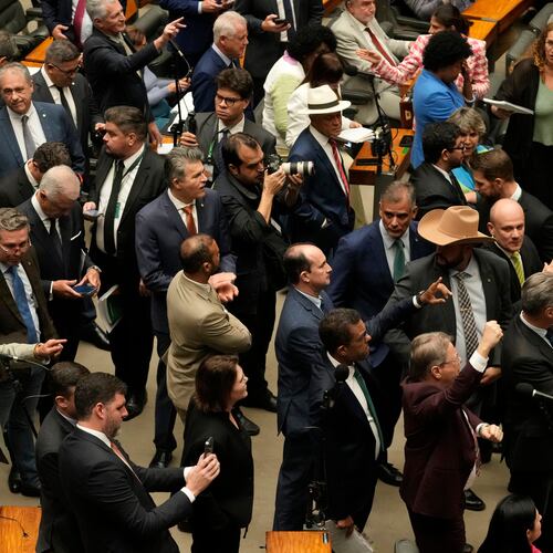 Congresspeople from parties supporting former President Jair Bolsonaro, sentenced for leading a coup attempt, attend a session to consider a bill to alter sentencing guidelines for certain crimes including coups d'état, in Brasilia, Brazil, Tuesday, Dec. 9, 2025. (AP Photo/Eraldo Peres)