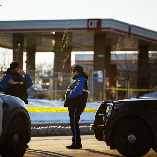 Omaha police investigate an incident at a QuikTrip gas station, that injured three officers and left the suspect dead in Omaha, Neb., Wednesday, Dec. 3, 2025. (Chris Machian/Omaha World-Herald via AP)