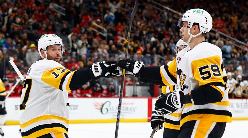 Pittsburgh Penguins right wings Bryan Rust (17) celebrates with Egor Chinakhov (59) after scoring a goal against the New Jersey Devils during the first period of an NHL hockey game, Thursday, April 9, 2026, in Newark, N.J. (AP Photo/Noah K. Murray)