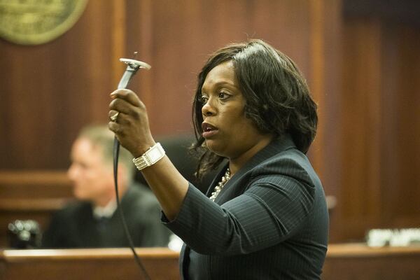 DeKalb County Assistant District Attorney Daysha Young uses a belt to demonstrate an example of physical abuse while giving her closing arguments during the trial of Jennifer and Joseph Rosenbaum in front of Henry County Judge Brian Amero at the Henry County SuperiorCourt in McDonough on Friday, July 26, 2019. (Alyssa Pointer/alyssa.pointer@ajc.com)