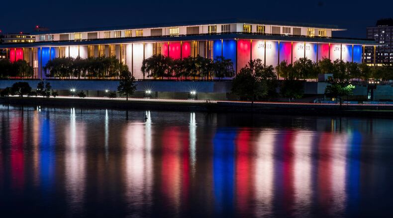 FILE - The red, white and blue lights, marking the 100th birthday of President John F. Kennedy, on the outside of the Kennedy Center for the Performing Arts are reflected in the Potomac River in Washington, May 26, 2017. AP Photo/J. David Ake, File)