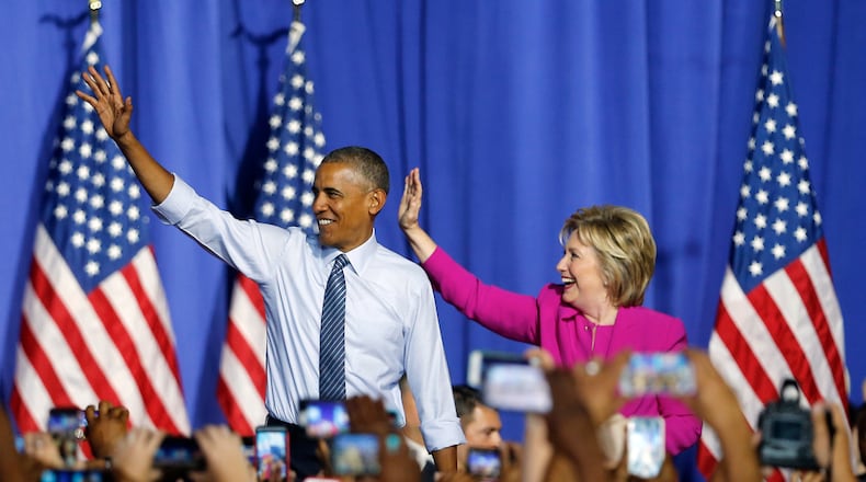 President Barack Obama and Democratic presidential candidate Hillary Clinton step on stage together for a campaign rally Tuesday, July 5, 2016, in Charlotte, N.C. (AP Photo/John Bazemore)