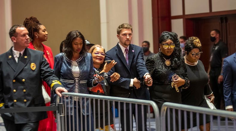 Rochelle Richardson (from right), Lynnette Hardaway (second from right) (known as Diamond and Silk); and Alveda King (fourth from right) are escorted into a ballroom at Cobb Galleria Centre before the start of a Blacks for Trump campaign rally in Atlanta, Friday, Sept. 25, 2020. (Alyssa Pointer / Alyssa.Pointer@ajc.com)