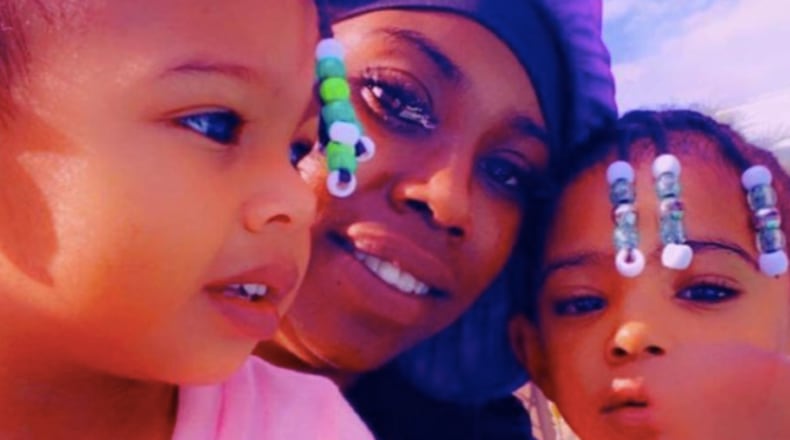 Queene Roux (center) and one of her children were killed in a crash on I-75, according to her family.