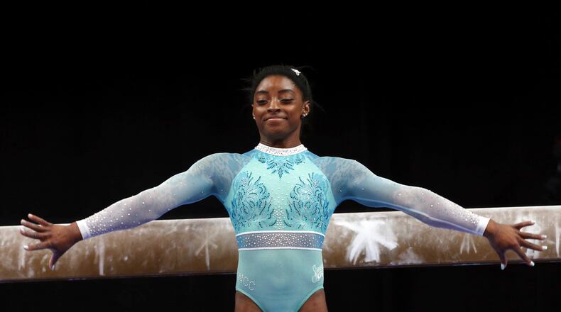 Simone Biles prepares to compete on the balance beam at the U.S. Gymnastics Championships, Sunday, Aug. 19, 2018, in Boston. (AP Photo/Elise Amendola)