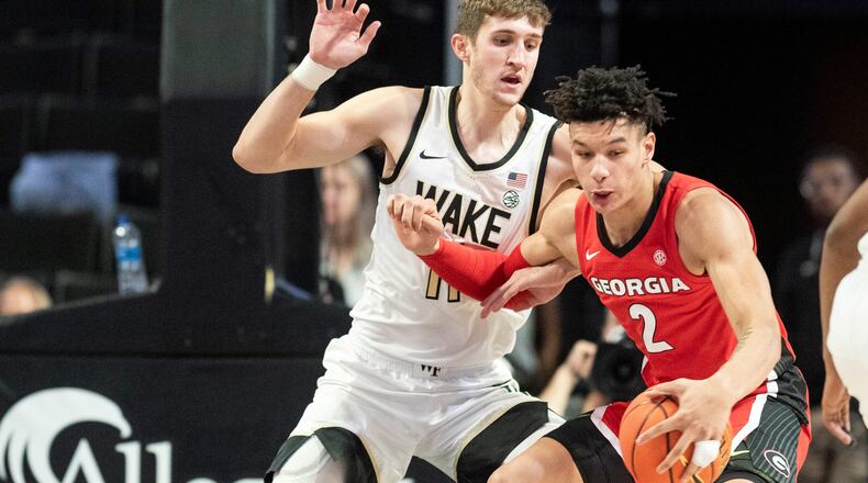 Wake Forest forward Andrew Carr (11) applies pressure to Georgia forward KyeRon Lindsay (2) in the first half of an NCAA college basketball game Friday, Nov. 11, 2022, in Winston-Salem, N.C. (Allison Lee Isley/The Winston-Salem Journal via AP)
