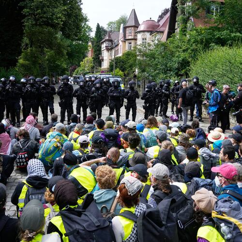 Police officers guard as protesters block a road during a rally against party convention of Alternative for Germany, or AfD in Erfurt, Germany, Saturday, July 4, 2026. (AP Photo/Ebrahim Noroozi)