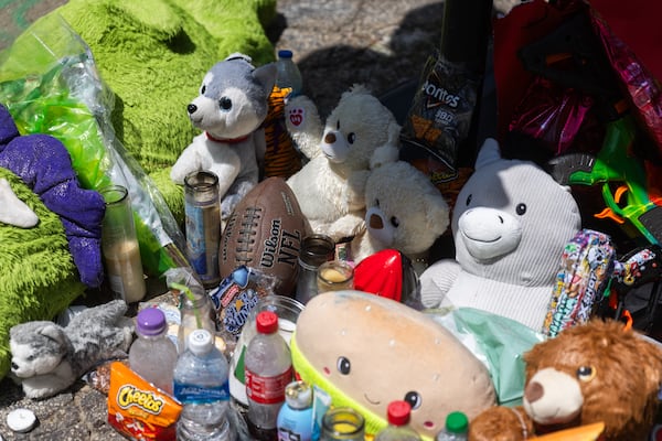 Stuffed animals, snacks and drinks rest at the base of a basketball goal with balloons in memoriam of Ja’Nylen Greggs in Atlanta on Friday, June 20, 2025. The apartment complex community is mourning 12-year-old Greggs after he was killed in the crossfire of a drive-by shooting. (Abbey Cutrer / AJC)