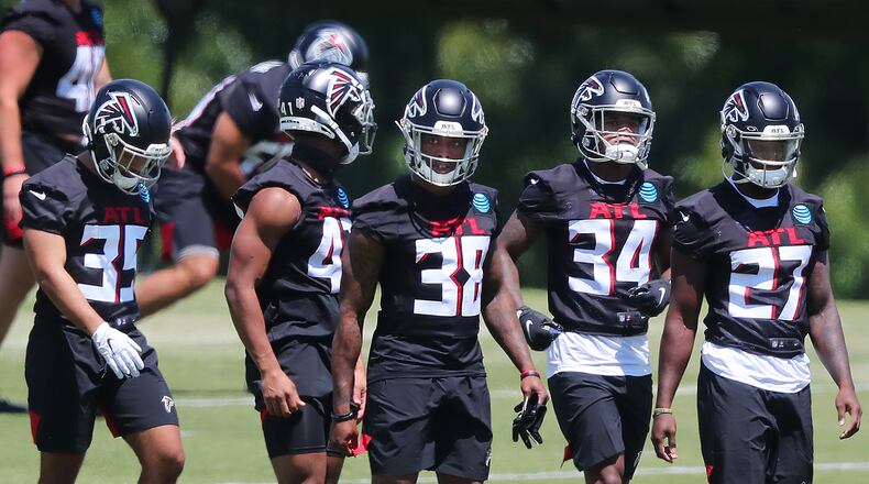 Falcons rookie cornerbacks and safeties Avery Williams (from left), JR Pace, Marcus Murphy, Darren Hall, and Richie Grant line up to run a defensive drill during rookie minicamp on Friday, May 14, 2021, in Flowery Branch. (Curtis Compton / Curtis.Compton@ajc.com)