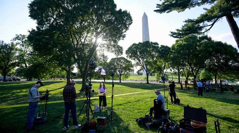 Journalists report as U.S. Secret Service and local police remain after a person was shot by law enforcement near the Washington Monument in Washington, Monday, May 4, 2026. (AP Photo/Rod Lamkey Jr.)