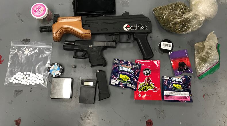 Police said guns and drugs were recovered from the car of a Jonesboro man who was involved in a road-rage incident Monday in Clayton County.