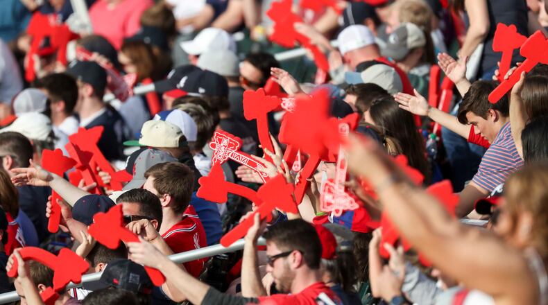 Braves fans perform the "Tomahawk Chop" during a game at SunTrust Park - now Truist Park - in Atlanta.