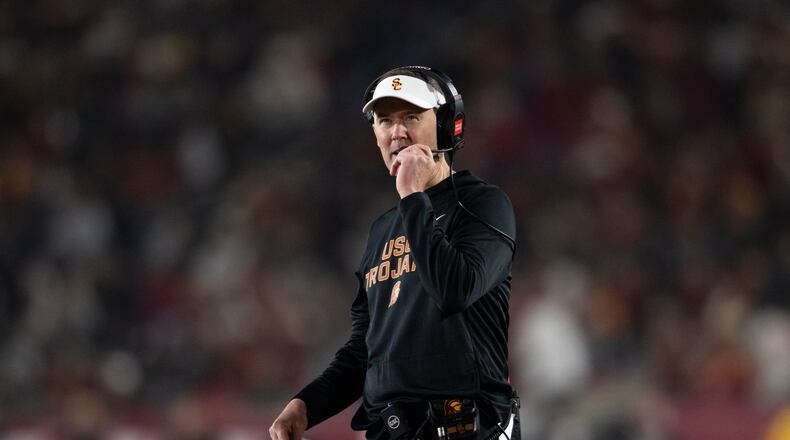 Southern California head coach Lincoln Riley walks on the field during the first half of an NCAA college football game against UCLA, Saturday, Nov. 29, 2025, in Los Angeles. (AP Photo/Kyusung Gong)
