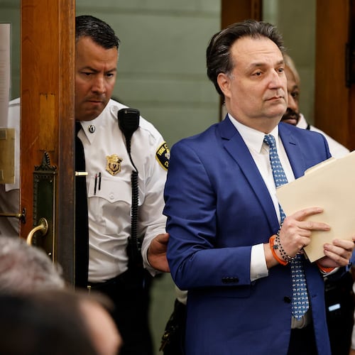 Brian Walshe enter the courtroom clutching papers and a rosary. Opening statements in the Brian Walshe murder trial in Norfolk Superior Court, Dedham, Mass., Monday, Dec. 1, 2025 (Greg Derr/The Patriot Ledger via AP, Pool)