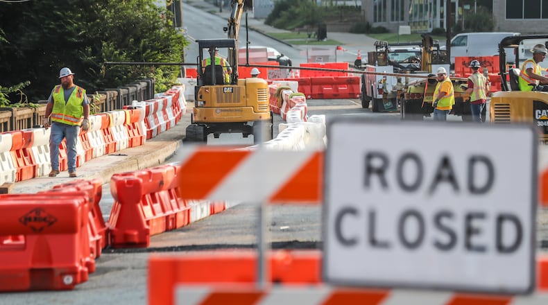 Workers repair a bridge on Cheshire Bridge Road after a fire Aug. 4.