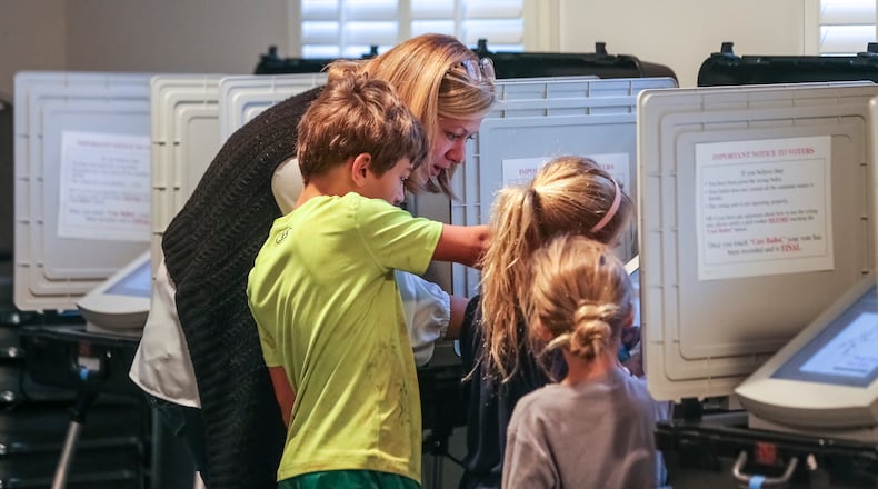 Sarah Jones votes with her children at The Gathering at the Church at Decatur Heights polling place  on Tuesday, Nov. 5, 2019.  JOHN SPINK/JSPINK@AJC.COM