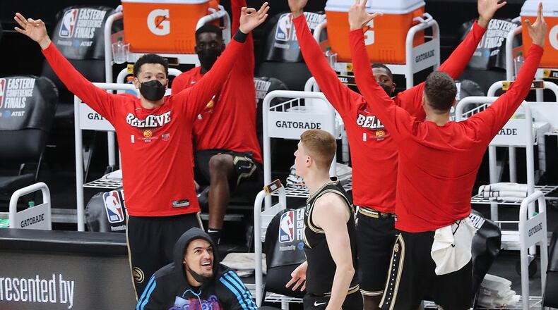 062921 Atlanta: Injured Atlanta Hawks guard Trae Young and the bench react as Kevin Huerter hits a three to take a 104-80 lead over the Milwaukee Bucks with 4:19 left during the fourth quarter in game 4 of the NBA Eastern Conference Finals on Tuesday, June 29, 2021, in Atlanta. The Hawks evened the series 2-2 with a 110-88 victory. “Curtis Compton / Curtis.Compton@ajc.com”