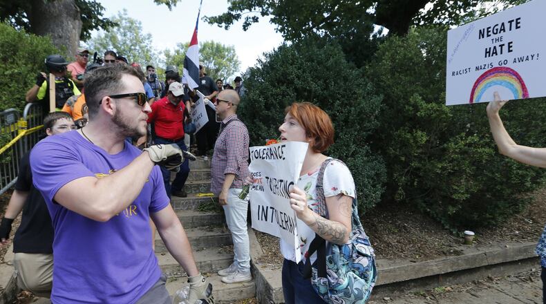 This 2017 image shows a white supremacist, left, being confronted by a counter demonstrator at a rally in Charlottesville, Va. Many worry incidents of hate crimes and bigotry are on the rise in the face of the coronavirus epidemic. (AP Photo/Steve Helber)