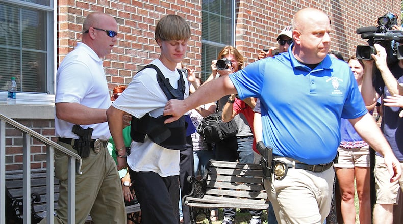 Charleston, S.C., shooting suspect Dylann Storm Roof is escorted from the Sheby Police Department in Shelby, N.C., Thursday, June 18, 2015. (AP Photo/Ben Earp)