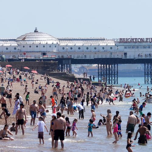 A view of the beach as people enjoy the hot weather in Brighton, East Sussex, England, Tuesday May 26, 2026. (Gareth Fuller/PA via AP)