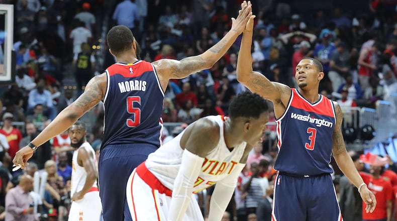 Washington Wizards’ Markieff Morris and Bradley Beal celebrate a 115-99 victory over Dennis Schroder and the Atlanta Hawks in Game 6 of a first-round NBA basketball playoff series on Friday, April 28, 2017, in Atlanta. Curtis Compton/ccompton@ajc.com