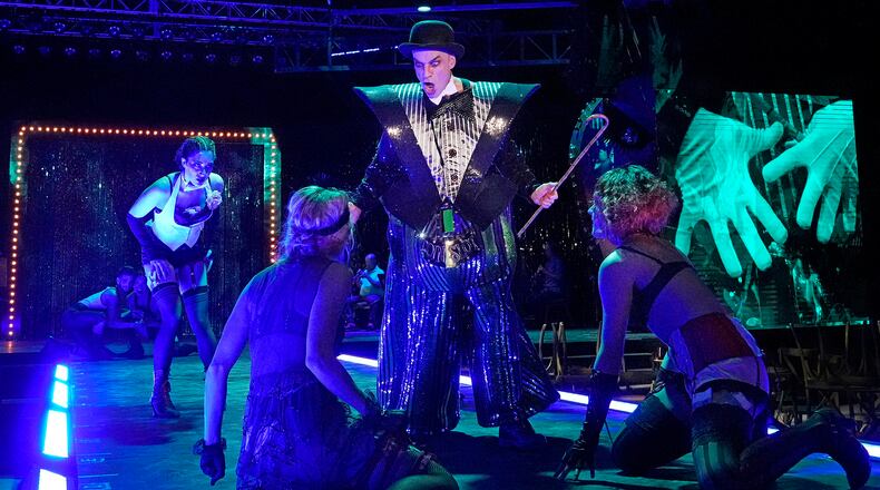 Atlanta Opera’s staging of the classic musical “Cabaret,” co-starring Curt Olds (center) as the Emcee, continues through June 19 in a warehouse setting at the Pullman Yards complex.
Courtesy of Ken Howard