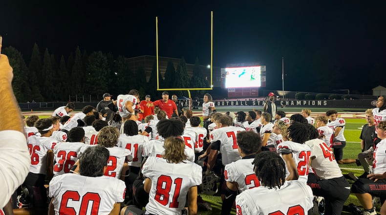 North Gwinnett coach Eric Godfree speaks to his team after their 37-34 win over Mill Creek on Sept. 6, 2024, in Hoschton.