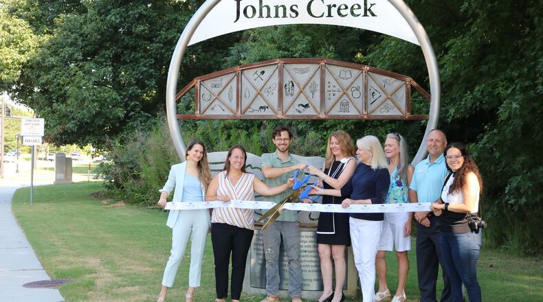 Representatives from the Johns Creek Convention and Visitors Bureau and artist William Massey (3rd from left) recently unveiled the city’s second gateway marker on State Bridge Road on the west side of the Chattahoochee River. (Courtesy City of Johns Creek)