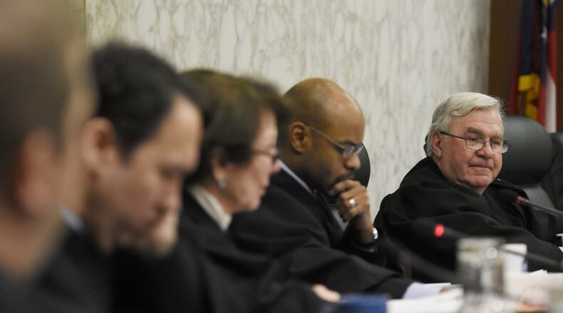 Chief Justice Harris Hines and other justices listen during oral arguments. Hines was recently summoned for jury duty in Cobb County.