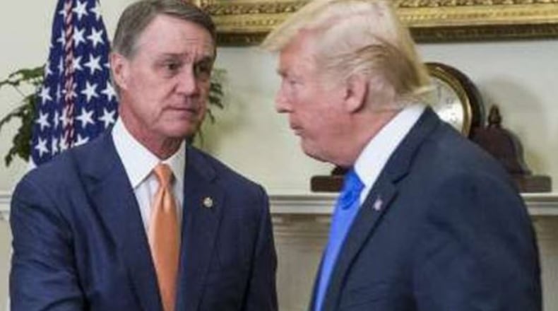 The election losses of then-U.S. Sen. David Perdue, left, and then-President Donald Trump get little mention in the Georgia GOP's "After Action Report." The autopsy of the 2020 campaign tends to focus on things the party sees as positives about its performance.