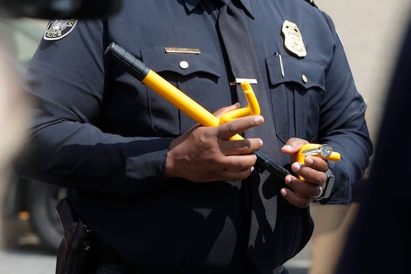 Atlanta Police Major Reginald Moorman holds a steering wheel lock to at Collier Heights Shopping Center in Atlanta on Wednesday, April 5, 2023. Vehicle thefts are on the rise as a result of the viral TikTok challenge in which people are hot wiring Kias and Hyundais with USB cables. (Natrice Miller/natrice.miller@ajc.com)