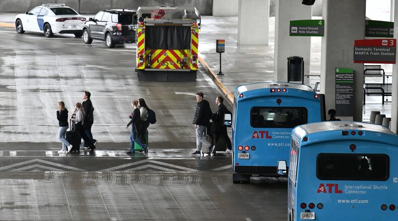 International travelers leave after they landed Maynard H. Jackson Jr. International Terminal. (Hyosub Shin / Hyosub.Shin@ajc.com)