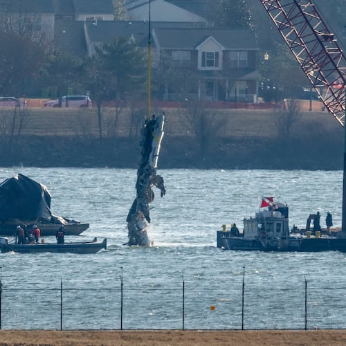 FILE - A piece of wreckage is lifted from the water onto a salvage vessel near the site in the Potomac River of a mid-air collision between an American Airlines jet and a Black Hawk helicopter, at Ronald Reagan Washington National Airport, Feb. 4, 2025, in Arlington, Va. (AP Photo/Ben Curtis, File)