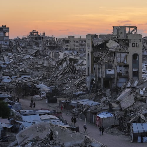 Palestinians walk amid war-damaged buildings in Gaza City, Wednesday, Sept. 23, 2026. (AP Photo/Jehad Alshrafi)
