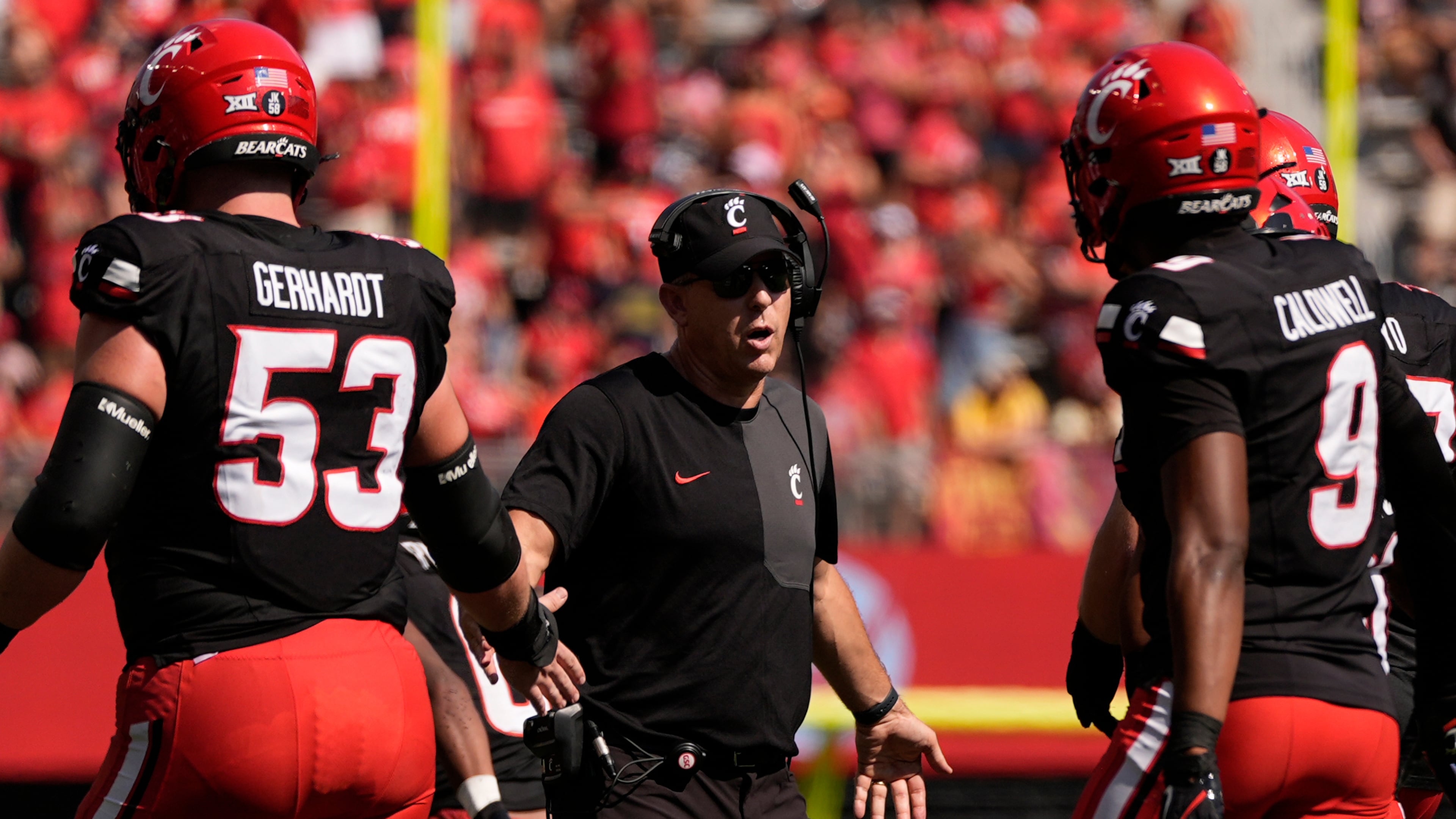 Cincinnati Bearcats head coach Scott Satterfield greets players on the field during the first half of an NCAA college football game against Iowa State , Saturday, Oct. 4, 2025, in Cincinnati. (AP Photo/Carolyn Kaster)