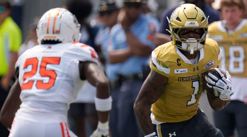Georgia Tech running back Trelain Maddox avoids Mercer linebacker Evin McDowell in the first half of Saturday's game in Atlanta. (Mike Stewart/AP)