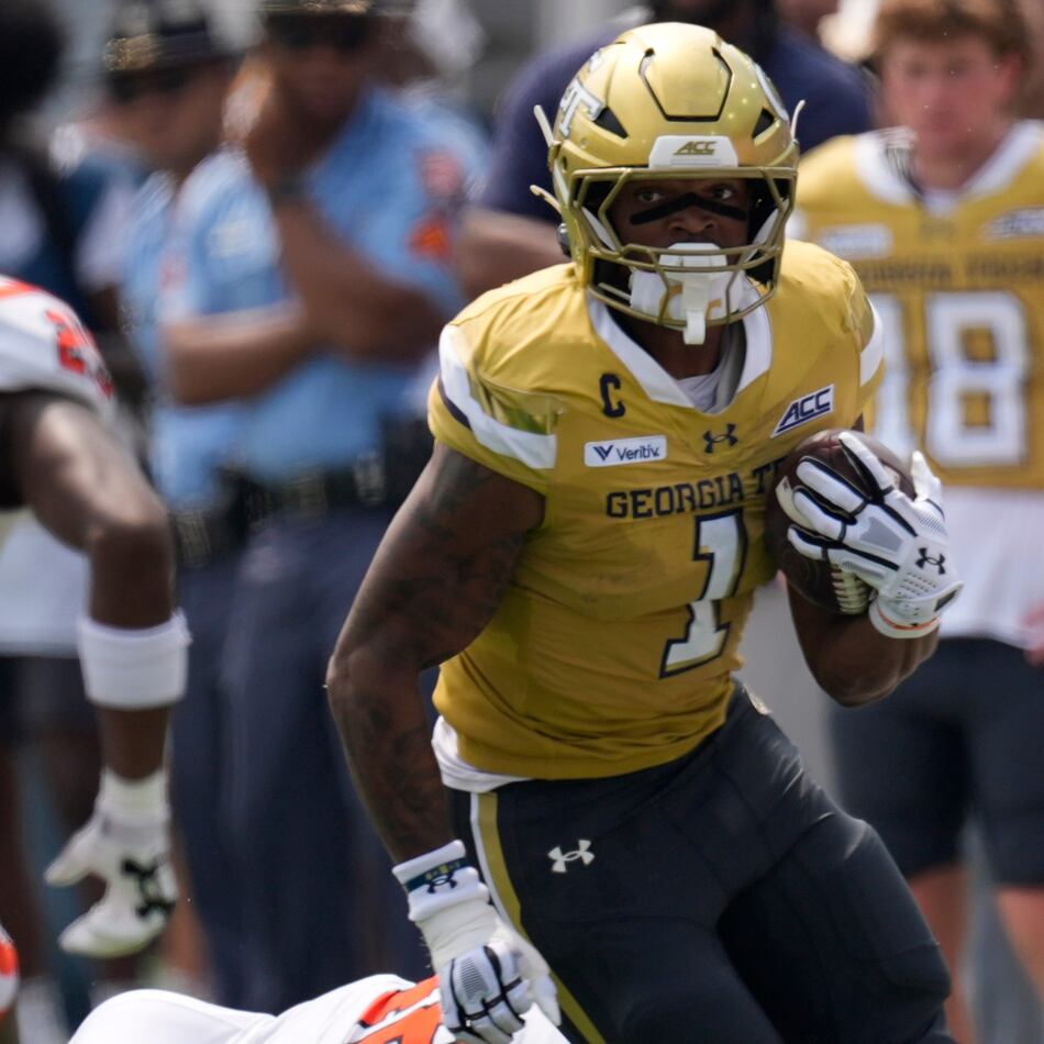 Georgia Tech running back Trelain Maddox avoids Mercer linebacker Evin McDowell in the first half of Saturday's game in Atlanta. (Mike Stewart/AP)