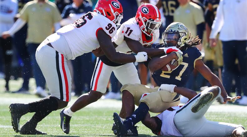 112721 Atlanta: Georgia defensive lineman Zion Logue (from left) and defensive back Derion Kendrick tackle Georgia Tech running back Jordan Mason for short yardage during the first half on the way to a 45-0 shut out in a NCAA college football game on Saturday, Nov. 27, 2021, in Atlanta.   “Curtis Compton / Curtis.Compton@ajc.com”`