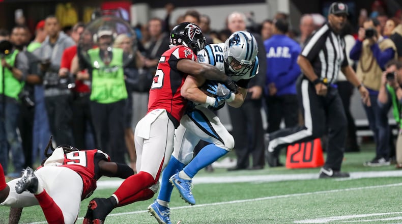 Carolina Panthers running back Christian McCaffrey (22) is tackled by Atlanta Falcons middle linebacker Deion Jones (45) during the second half of the game at Mercedes Benz Stadium, Sunday, December 31, 2017. The Atlanta Falcons beat the Carolina Panthers, 22-10.  ALYSSA POINTER/ALYSSA.POINTER@AJC.COM