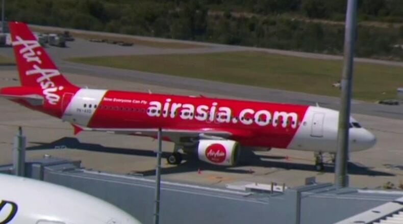 This Sunday, Oct. 15, 2017 image made from video shows an AirAsia plane at an airport in Perth, Australia. Passengers on the Indonesia AirAsia flight from Australia to the holiday island of Bali described a panicked flight crew announcing an emergency and oxygen masks dropping from the ceiling after their airliner lost cabin air pressure and rapidly descended. (Channel 9 via AP)