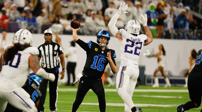 Detroit Lions quarterback Jared Goff (16) throws under pressure from Minnesota Vikings safety Harrison Smith (22) during the second half of an NFL football game, Thursday, Dec. 25, 2025, in Minneapolis. (AP Photo/Bruce Kluckhohn)