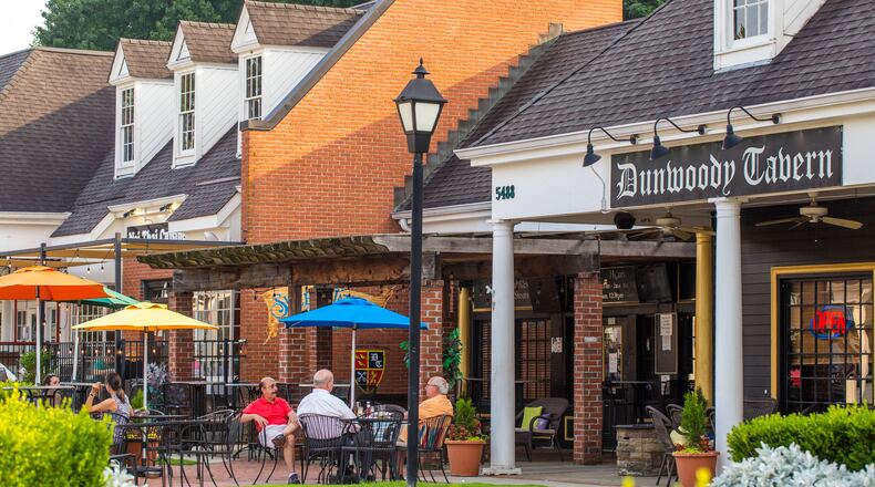 Dunwoody Village businesses, including those in The Shops of Dunwoody strip mall, may soon have a new city center, in the mean time the locals enjoy whatever green space and outdoor patios they can find in the multiple shopping complexes, patched together in the area on Thursday, July 22, 2021.  (Jenni Girtman for The Atlanta Journal-Constitution)