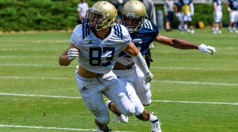 Georgia Tech wide receiver Brad Stewart looks for the ball as cornerback Lamont Simmons provides coverage in a practice on August 7, 2018. (Danny Karnik/Georgia Tech Athletics)