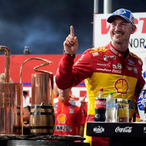 Joey Logano poses with the trophy in Victory Lane after winning a NASCAR Cup Series auto race in North Wilkesboro, N.C., Sunday, July 19, 2026. (AP Photo/Chuck Burton)