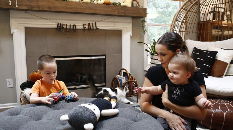 Kelly Pohly left her marketing job in July to stay home with their three sons after the pandemic increased stress about finding child care, working from home and figuring out the boys' schooling. She is seen with sons Anderson, 3, and Graham, 10 months old, at their Westerville, Ohio, home. (Fred Squillante/Columbus Dispatch/TNS)