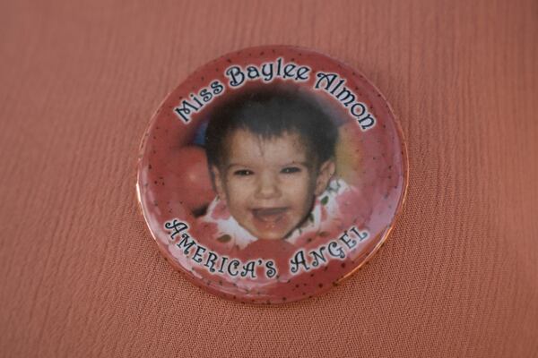 Aren Almon wears a button with a photo of her daughter Baylee Almon, who was killed in the Oklahoma City federal building bombing, at the Oklahoma City National Memorial on Wednesday, April 9, 2025. (AP Photo/Nick Oxford)